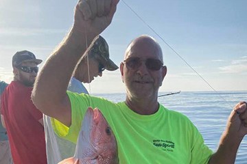 a man holding a fish