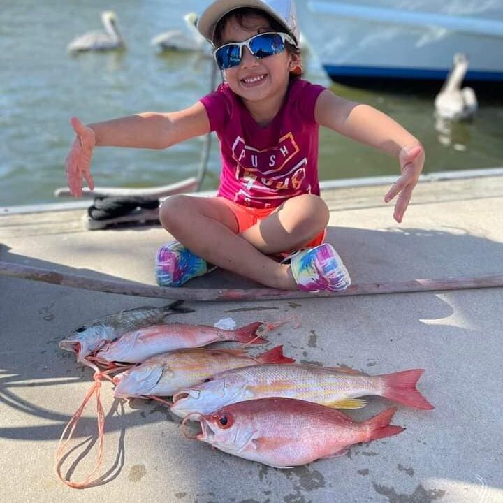 a woman holding a fish