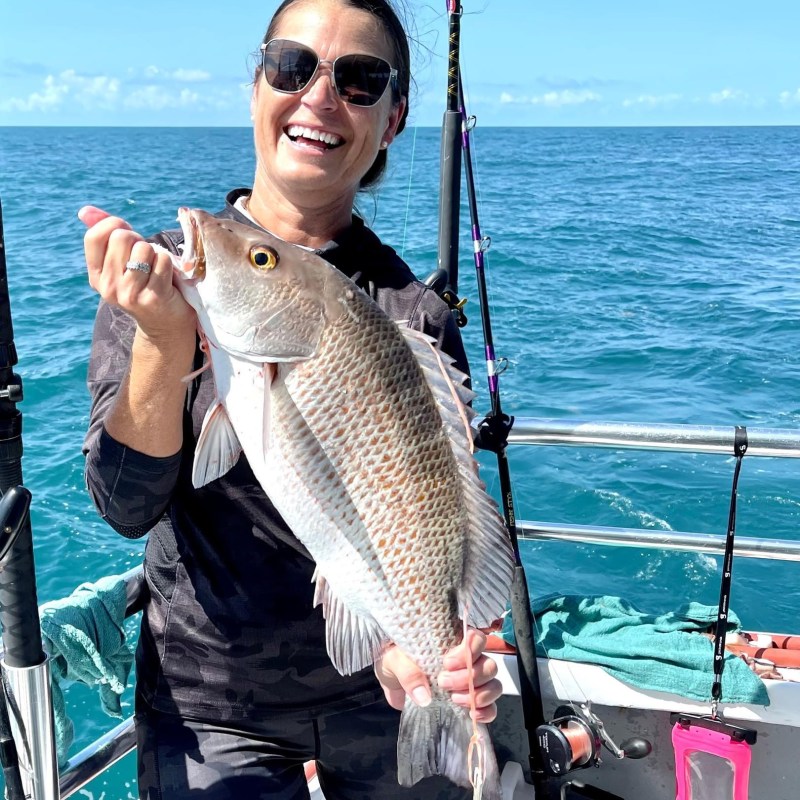 a person holding a fish in the water
