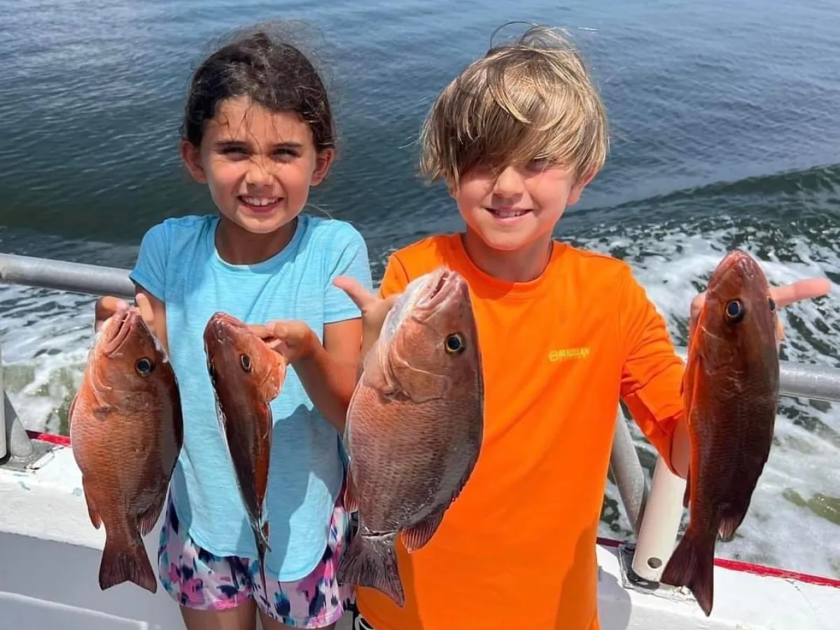 a person holding a fish in the water