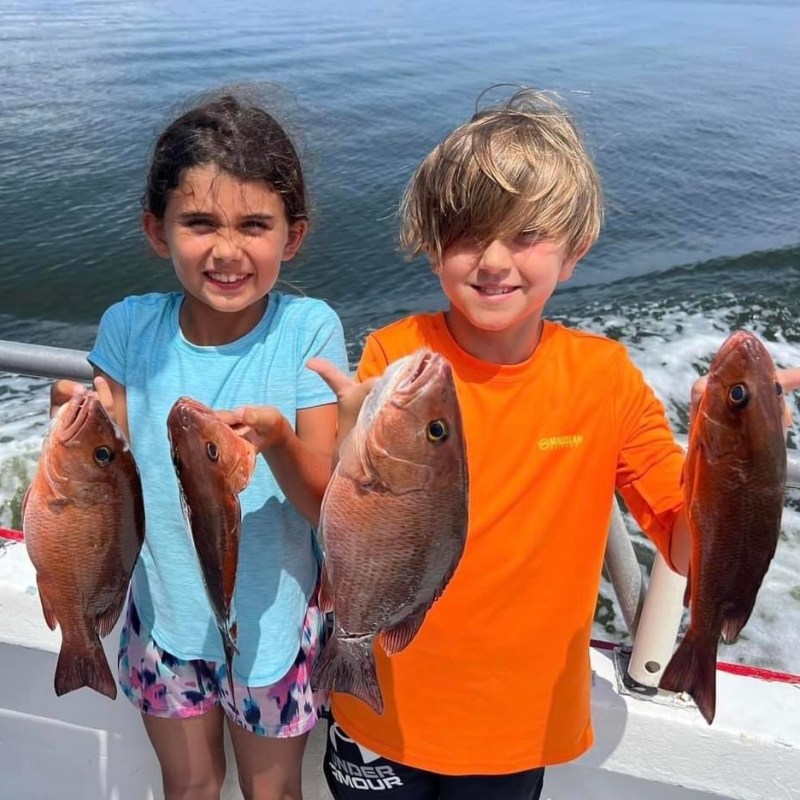 a person holding a fish in the water