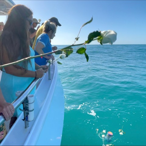 a group of people on a boat in the water